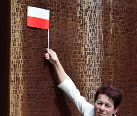 Wyjazd z min. Piotrem Glińskim (9 czerwca 2018), Barbara Gawlicka pokazuje na Bramie Pamięci nazwisko dziadka, Władysława Linsenmana